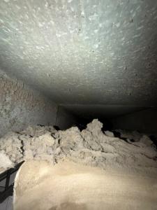 Dust and debris visible inside a metal air duct