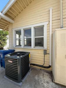 Outdoor air-conditioning condenser next to a house