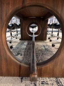 Circular cutouts and stretcher detail in custom conference table base