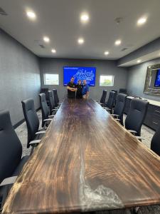 David Barrett with upright custom live-edge conference table at Akins Ford