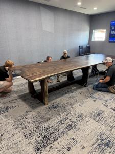 Installing hidden electrical and data wiring through hollowed leg base of Akins Ford conference table