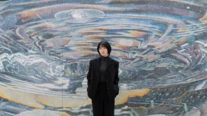 Contemporary artist Ejae Park standing in front of painting