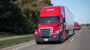 Several Roehl Transport trucks driving on the road