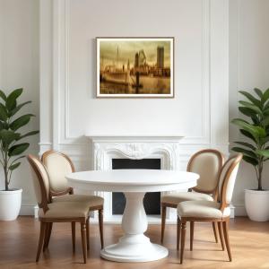 Gold-toned ICM abstract London cityscape displayed above a white fireplace in an elegant dining room with warm wood and neutral furnishings.