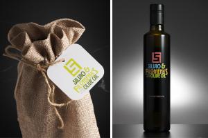 Burlap gift bag with a Silvio & Filomena’s Olive Oil logo tag beside a dark glass bottle featuring the custom extra virgin olive oil label design.