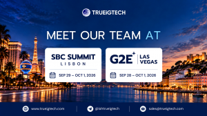 TRUEiGTECH event banner showing G2E Las Vegas and SBC Summit Lisbon 2026 dates with Las Vegas and Lisbon skylines, company logo, and contact details