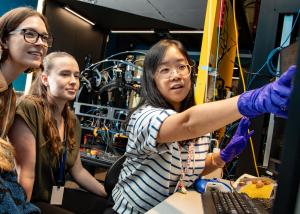 Female scientist gesturing to a computer screen