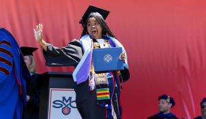 A Saint Mary's student happily crosses the Commencement stage