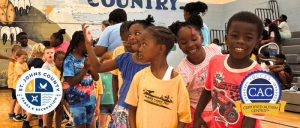 Children of diverse backgrounds smiling and playing together in a gymnasium, with St. Johns County Parks & Recreation and Certified Autism Center logos.