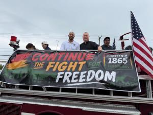 People atop a firetruck