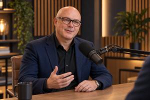 Andrew Buzinsky talking into a microphone during a webinar