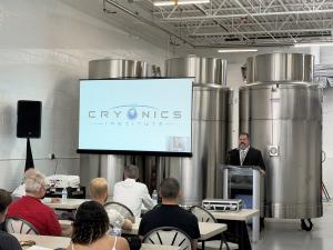 CI President Dennis Kowalski addresses attendees during the facility tour, with cryogenic storage dewars in the background.