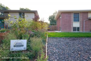 Side-by-side yards: at left, a newly planted High Country Gardens waterwise garden with a transformation sign; at right, a gravel lawn with turf grass.