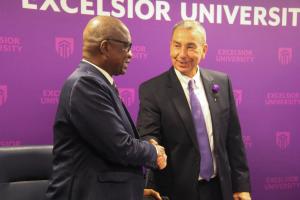 Two men shake hands.