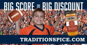 An excited boy wearing an orange and blue jersey is shown with a football and a jar of Tradition Spice seasoning, cheering in front of a crowd of football fans. The text reads "Big Score = Big Discount. TraditionSpice.com"