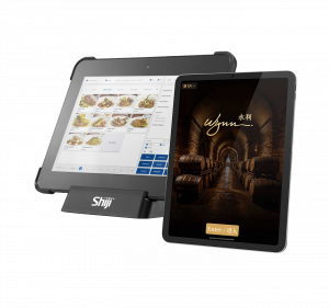 Two point-of-sale touchscreen devices, one displaying a restaurant menu with images of various dishes, the other showing a wine cellar background with the words Wynn and Enter.