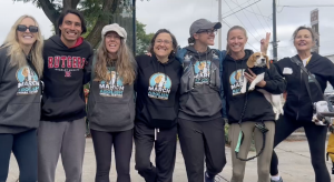 MAAT co-lead Ella Magers, her lab beagle Jane, co-lead Gretchen Primack and supporters, on a break from marching.