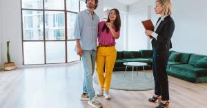 Couple and property manager discussing a final inspection in an empty Perth apartment