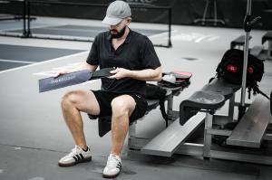 HeelBase DRIVE insoles shown courtside with pickleball equipment.