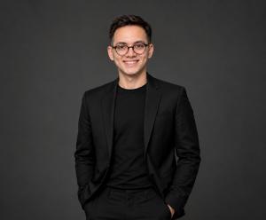 Hanzala Omar, Founder and CEO of Stonebridge Creative Technologies, pictured in a black suit.