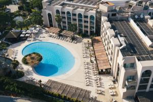 Aerial view of Falésia Hotel in Albufeira, Algarve, showing the outdoor swimming pool, sun terrace, gardens and hotel buildings.