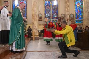 Parishioner Leonardo Maciel presents flags of migrant nations to United States during Offertory at St. John Scalabrini 125th Anniversary Mass at Our Lady of Pompeii Church. Photo Credit: Jeffrey Bruno