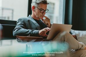 Businessman reading Forbes® article series of Swiss Security Solutions