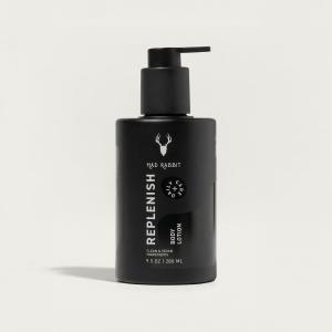 Black Mad Rabbit Replenish Body Lotion pump bottle on a light background