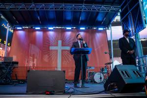 Mike Signorelli, author of The Unoffendable Heart, preaching on stage in Times Square, New York