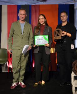 Ana Luisa Braun Rodrigues, winner of the Only Natural Student Design Competition 2026 Accessories Category and Overall Fashion title, stands between Grant Gibson and Amanda Symm while holding her winner’s certificate.