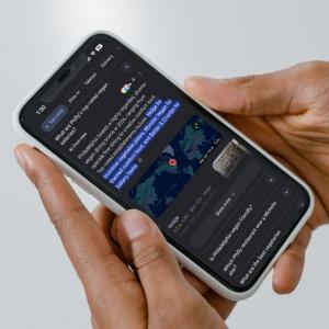 Phone screen showing a Google AI Overview responding to "What are Philly's top-rated vegan eateries?" with a written answer citing specific restaurants, a map, and a listing for Vedge.