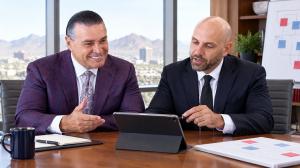 Jeffrey Phillips and Nasser Abujbarah collaborating in a Phillips Law Group conference room.