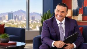 Jeffrey Phillips seated in a Phoenix office, preparing to speak with a client.