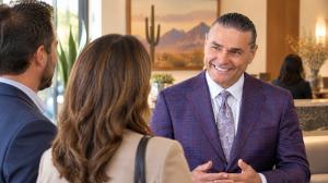 Jeffrey Phillips speaking with community members in a Phoenix office reception area.