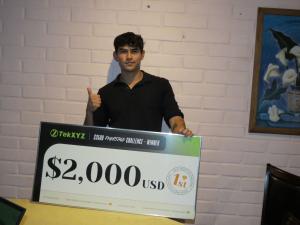 Benjalao with his $2,000 first-place prize check
