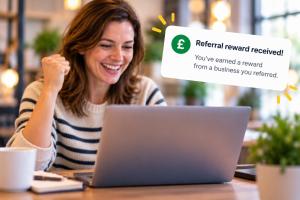 Woman getting referral reward while working on laptop