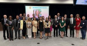 Candidates pose in group photo in meeting room of Asian American Alliance Candidate Forum