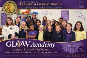 Chef Stormy Mongiello speaks at the Glow Girls Academy in Wilmington, NC. Featured in the back is Chef Lori Eaton and many of the girl students.