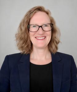 Woman in blue suit smiling