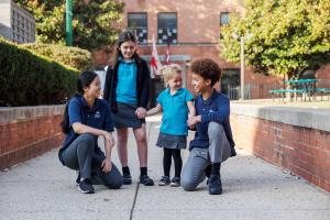 Four British International School of Washington students of different ages together on the school campus in Washington, D.C.