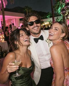 Three friends laughing together at an evening party, a candid guest photo shared with My Glam Cam