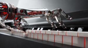 A metallic robotic hand playing a piano keyboard, illuminated by red light.