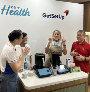 Two GetSetUp Guides, who are older adults lead an ice cream making session with two other older adults during the launch of the NTUC and GetSetUp collaboration.