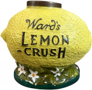 Wards Lemon-Crush syrup dispenser, an early ceramic soda fountain syrup dispenser molded in the form of an oversize lemon with textured yellow surface. Estimate: $800-$1,600