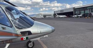 Agusta A109 helicopter on the private jet ramp at Toluca International Airport, ready for transfers to the Mexico City Grand Prix