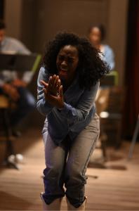 Armani Greer, in a denim shirt and white cowboy boots, performs an emotional scene from The Weight of Silence