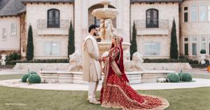 South Asian bride and groom in traditional wedding attire at a wedding venue, featured by Jab We Wed, a South Asian wedding vendor marketplace. Photo credit: Black Iris Photography.