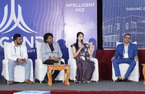 Dr. Mariko Kitamura holding a microphone and speaking during a panel discussion with three other speakers at ASCEND 2026