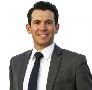 Professional headshot of Brian Filmore, estate planning attorney at Copper Canyon Law, wearing a gray suit and dark tie.