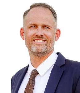 Professional headshot of Stephen Rogers, estate planning attorney at Copper Canyon Law, wearing a navy suit and patterned tie.
